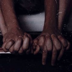 two hands on top of a laptop computer with water droplets all over the screen and in front of them