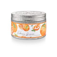 an orange scented candle in a tin on a white background with the words citrus grove