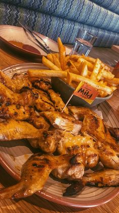 chicken wings and french fries on a plate