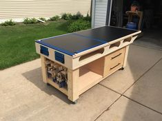 an image of a workbench made out of wood and plastic boxes with tools in it