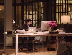 a person sitting at a desk with a laptop