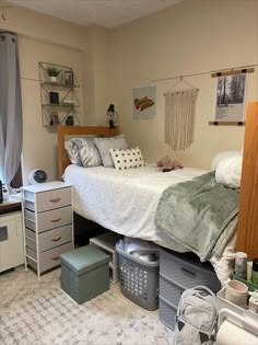 a bed room with a neatly made bed and lots of clutter on the floor