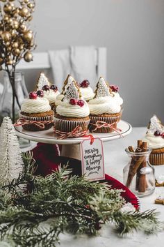 christmas cupcakes with white chocolate frosting on a platter