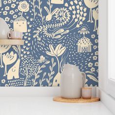 a blue and white wallpaper with animals, flowers and birds on it in a kitchen