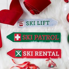 ski lift, ski patrol, ski rental sign and christmas ornaments on white fur background