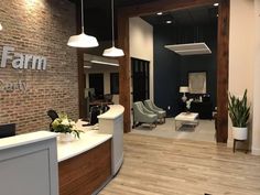 an office lobby with brick walls and wood floors