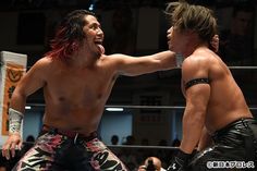 two men are wrestling in an indoor ring