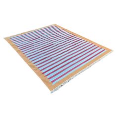 an orange and blue striped rug on a white background