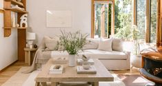 a living room filled with furniture and lots of windows