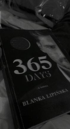 a person is holding a book in their hand with the title 365 days written on it