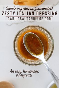 an easy homemade italian dressing recipe in a glass jar with a spoon on the side