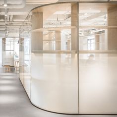 an office with glass partitions and white walls