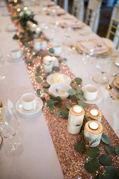 a long table with candles and flowers on it is set up for a formal dinner