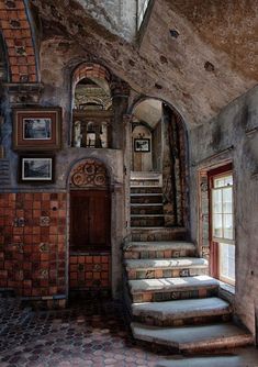 an old building with stairs and pictures on the wall