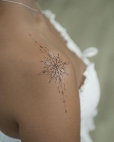 a woman with a flower tattoo on her shoulder