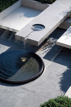 an outdoor fountain with water flowing from it