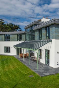 Double height marine grade glazing to new build on a sloping site House On Slope, Glass Facades, Front Elevation, New Builds, Cornwall, Art Deco Fashion, Steel Frame, New Homes, Art Deco