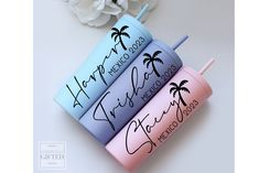 three personalized travel mugs with the names of two different countries and palm trees