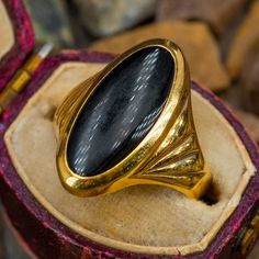 This wonderful vintage ring features an oval cabochon cut onyx and is crafted of 14k yellow gold. This ring is currently a size 7. Luxury Oval Cabochon Engagement Ring, Luxury Elegant Cabochon Sapphire Ring, Luxury Polished Oval Cabochon Dome Ring, Luxury Wedding Rings With Oval Cabochon, Luxury Oval Cabochon Brooch Jewelry, Luxury Classic Ring-shaped Cabochons, Luxury Oval Cabochons With Bezel Setting, Luxury Vintage Moonstone Oval Cabochon Ring, Luxury Vintage Cabochon Jewelry