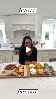 a woman sitting in front of a table full of food on it, with the words board written below her