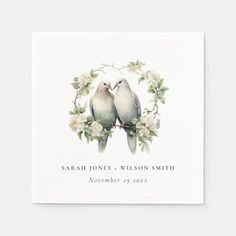 two birds sitting on top of each other in front of a white background with flowers