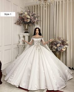 a woman in a white wedding dress standing next to flowers