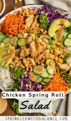 chicken spring roll salad with carrots, cucumbers and shredded cabbage in a white bowl