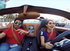 two people sitting in the driver's seat of a car