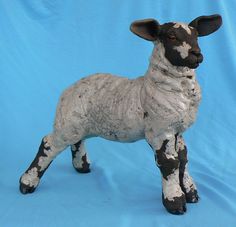 a statue of a sheep on a blue background