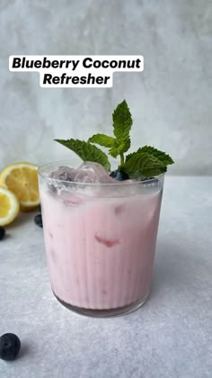 blueberry coconut refresher in a glass with ice and mint garnish