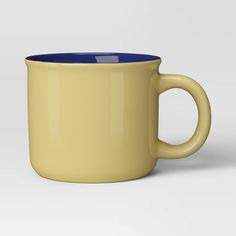 a yellow and blue coffee mug on a white background with the bottom half turned down