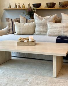 a coffee table with books on it in front of a couch