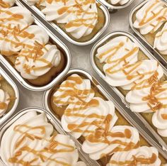 cupcakes with icing and caramel drizzle on them in tins