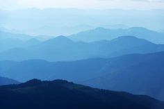 the mountains are covered in blue haze