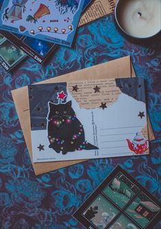 a table topped with cards and candles next to a candle on top of a blue blanket