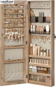 an open wooden cabinet with jewelry and bracelets on it's shelves in front of the door