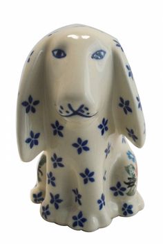 a ceramic dog figurine with blue flowers on it's body and ears