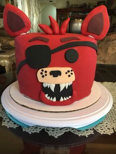 a red cake with an animal head on top