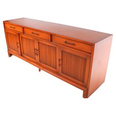 a large wooden cabinet with two doors and drawers