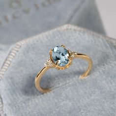 Pale Blue Aquamarine & Diamond Ring, Oval Cut Engagement Ring, Unique Minimalist 14k Gold Ring, Handmade Diamond Cluster Ring, Gift for Her ★ ★ ★ ★  CUSTOM/DUTY-FREE SHIPPING WORLDWIDE, BUYERS DON'T HAVE TO PAY ANY CUSTOM FEES WHILE IMPORTING ★ ★ ★ ★  Details Made to order Material: 14k/18k gold Color Options: Yellow Gold, White Gold, Rose Gold ★ Center Stone Aquamarine, Oval Size: 5 x 7 mm  Approx Weight (Ct): 0.82 ★ Accent Stones Diamond/Moissanite Round Size: 1.2 mm * 6 Nos.   Approx Weight (Ct): 0.04 ★ Ring Height: 7.5 mm ★ Band Width: 1.5 mm ★ 100% Natural Diamond and Gemstones ★ Diamond: Round Brilliant cut, G-H Color, SI Clarity ☂ Shipped with Insured Shipping within 4-7 business days. ➦ 100% Free Returns. ➦ Our Jewelry comes with a Lifetime Warranty. (Stone Replacement not included Aquamarine Engagement Ring Gold, Oval Aquamarine Ring, Diamond Ring Oval, Engagement Ring Gold, Blue Opal Ring, Oval Cut Engagement Ring, Future Engagement Rings, Engagement Ring Unique, Aquamarine Engagement Ring