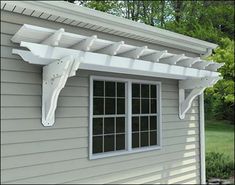 an outside view of a house with a white awning