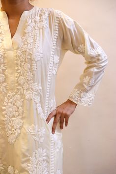 Introducing our exquisite Pure Silk Kurta, a masterpiece of luxury and elegance. This opulent cream-colored Kali kurta is adorned with intricate vintage Chikankari embroidery, showcasing the rich heritage of craftsmanship. The delicate gold Mukaish embellishments add a touch of glamour and sophistication, creating a truly mesmerizing ensemble. Handcrafted with precision and attention to detail, this luxurious cream silk kurta offers a seamless blend of comfort and style. The sumptuous fabric drapes effortlessly, providing a regal feel and ensuring you look and feel your best on any occasion. Whether you're attending a formal event, celebrating a special occasion, or simply indulging in refined fashion, this Pure Silk Kurta with vintage Chikankari embroidery and gold Mukaish embellishments Luxury Silk Kaftan With Chikankari Embroidery, Elegant Unstitched Fabric With Intricate Embroidery, Elegant Silk Fabric With Chikankari Embroidery, Elegant Embroidered Fabric For Designer Wear, Elegant Chikankari Embroidered Fabric For Wedding, Elegant Embroidered Straight Kurta Fabric For Festive, Elegant Embroidered Fabric For Designer Festivals Wear, Elegant Embroidered Fabric For Designer Wear And Festivals, Elegant Intricate Embroidered Fabric For Festive Season