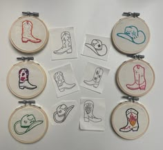 nine embroidered pictures of cowboy boots and hats are displayed on a white surface with metal pins