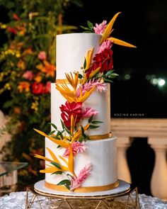 three tier white buttercream cake with tropical flowers Wedding Cake Designs Tropical, Island Theme Cake, Tropical Cake Ideas, Tropical Flower Wedding Cake, Tropical Wedding Cake Toppers, Two Tier Tropical Wedding Cake, Tropical Glam Cake, Hawaiian Wedding Cake, Brazil Wedding