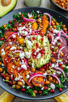 a salad with carrots, avocado and chickpeas is on a plate