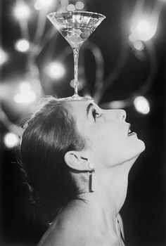 a woman with a martini glass on her head