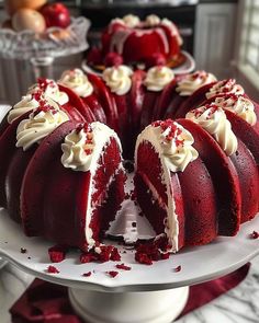 a red velvet cake with white frosting and sprinkles on a plate