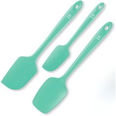 three green spatulas and two spoons on a white background with the same color