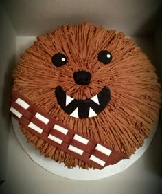 a star wars themed cake in a box with the face of chewbam on it