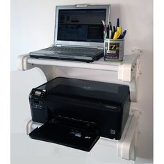 a laptop computer sitting on top of a shelf